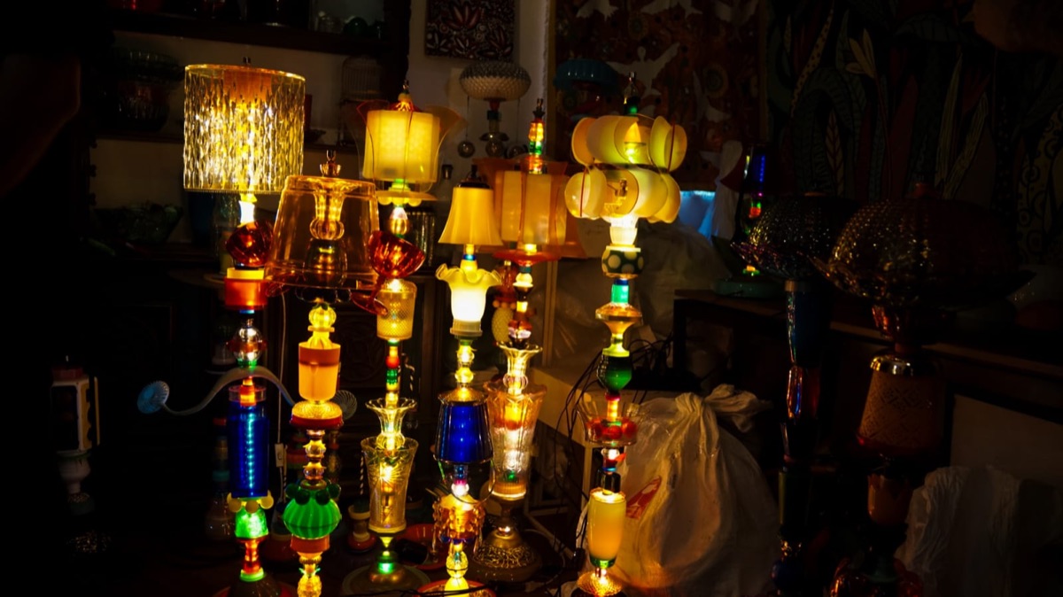 Conjunto de luminárias de garrafas PET acesas expostas lado a lado